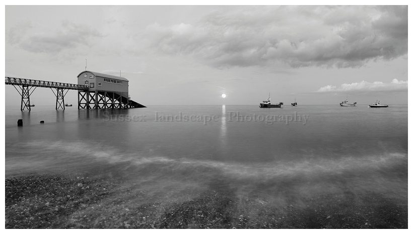 slides/Selsey Bill Mono Moon Rise.jpg full moon,rising,selsey bill, west sussex,coast,water,boats, royal national life boat institution,mono,black and white Selsey Bill Mono Moon Rise